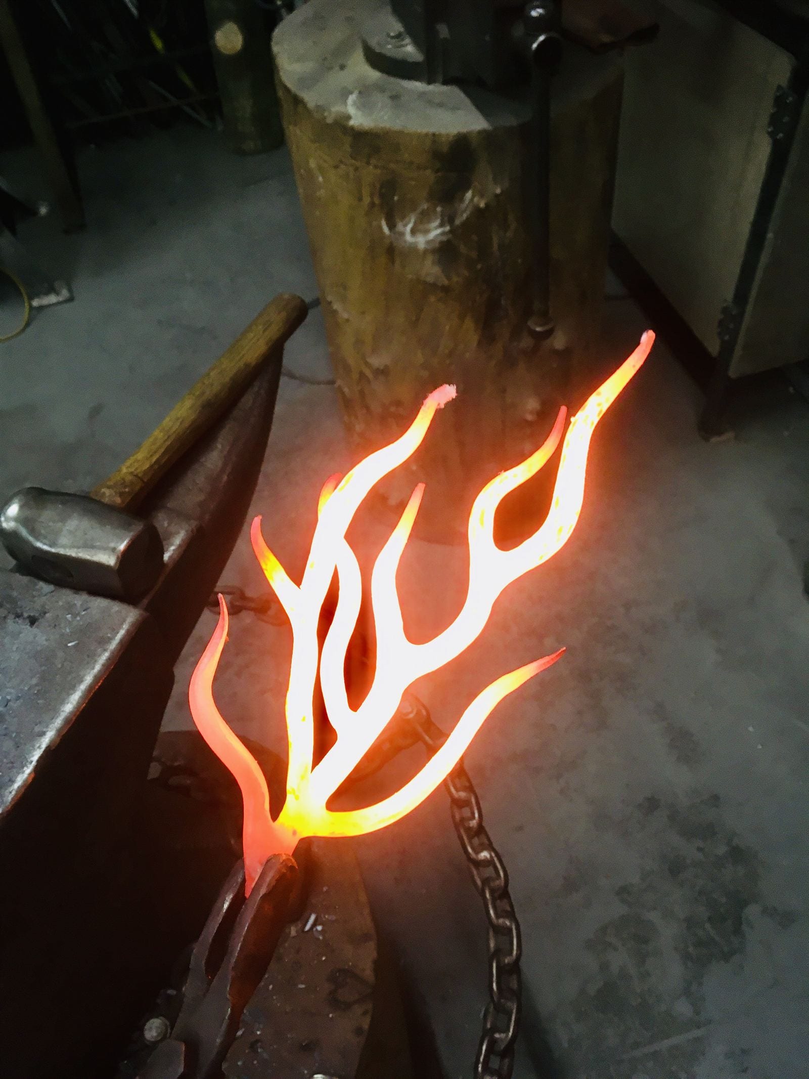 A branch of steel glowing white hot on the anvil