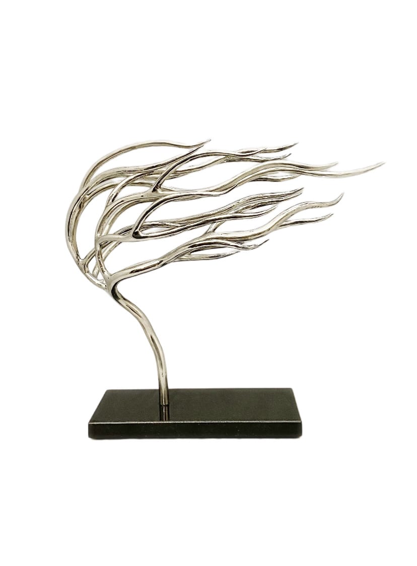 A windswept tree in polished steel standing on a forged base