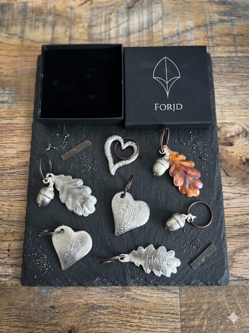 The keepsake range laid out on slate beside a FORJD box